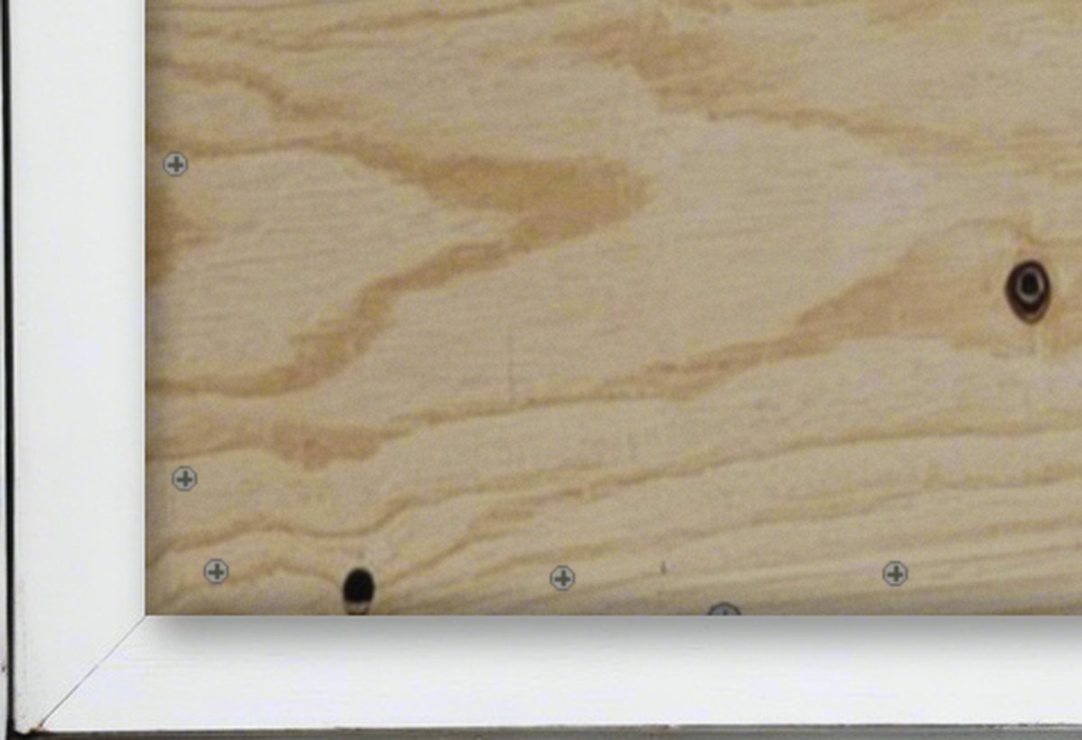 Plywood screwed to the window frame, sill swept clear of glass